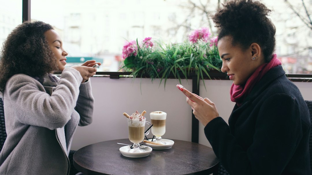 Two people having a conversation over coffee in a cafe